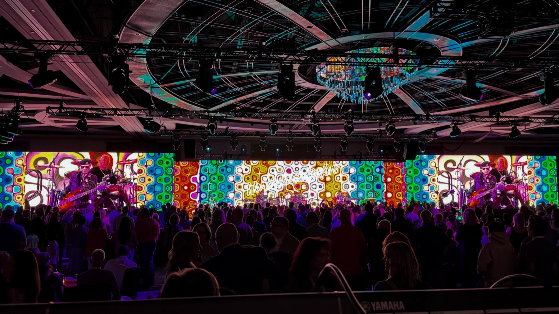 Live band in front of a psychedelic floor-to-ceiling LED wall