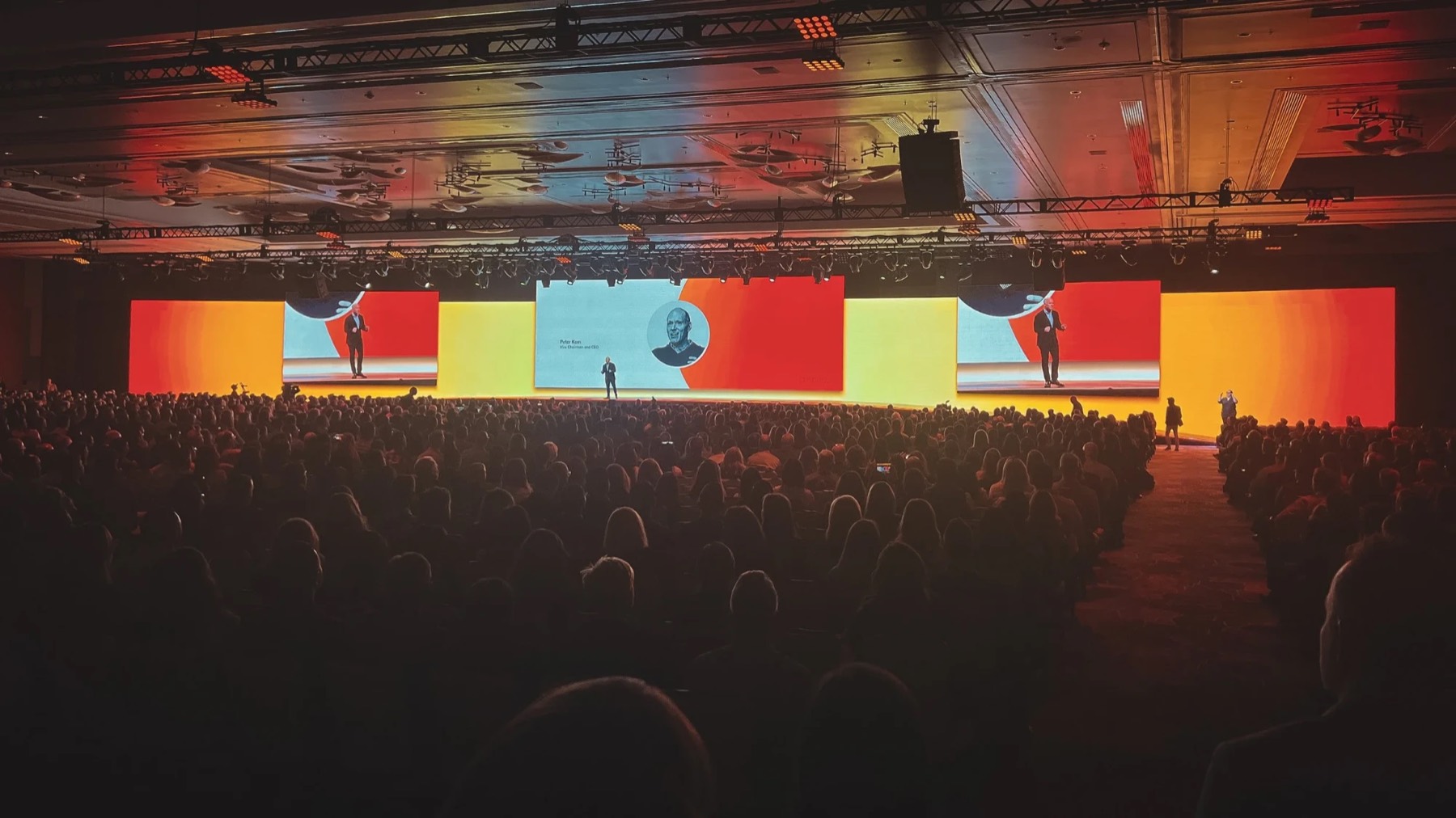 CEO keynote on a wide red and yellow LED stage