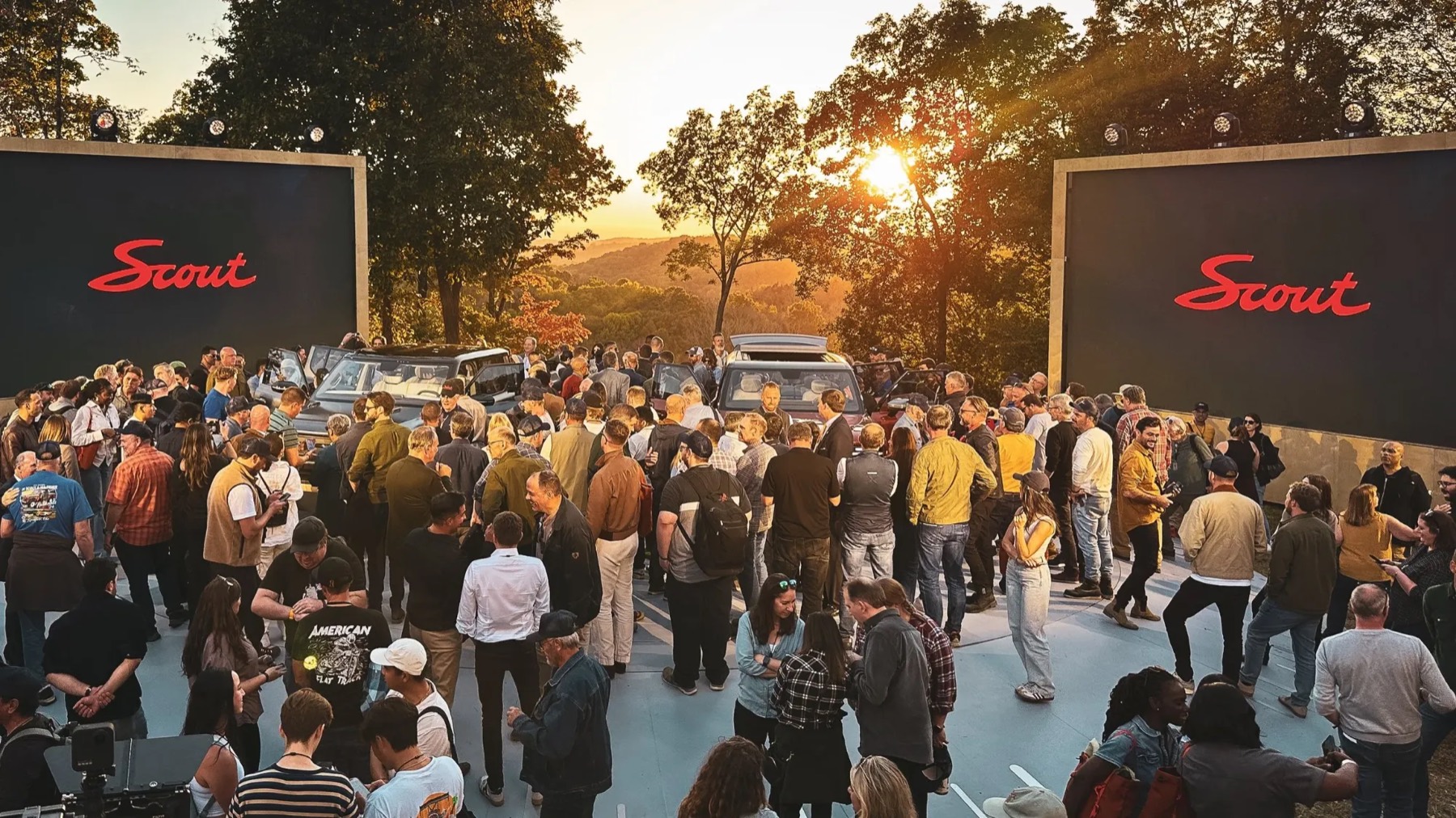 Outdoor vehicle reveal between twin LED walls at sunset