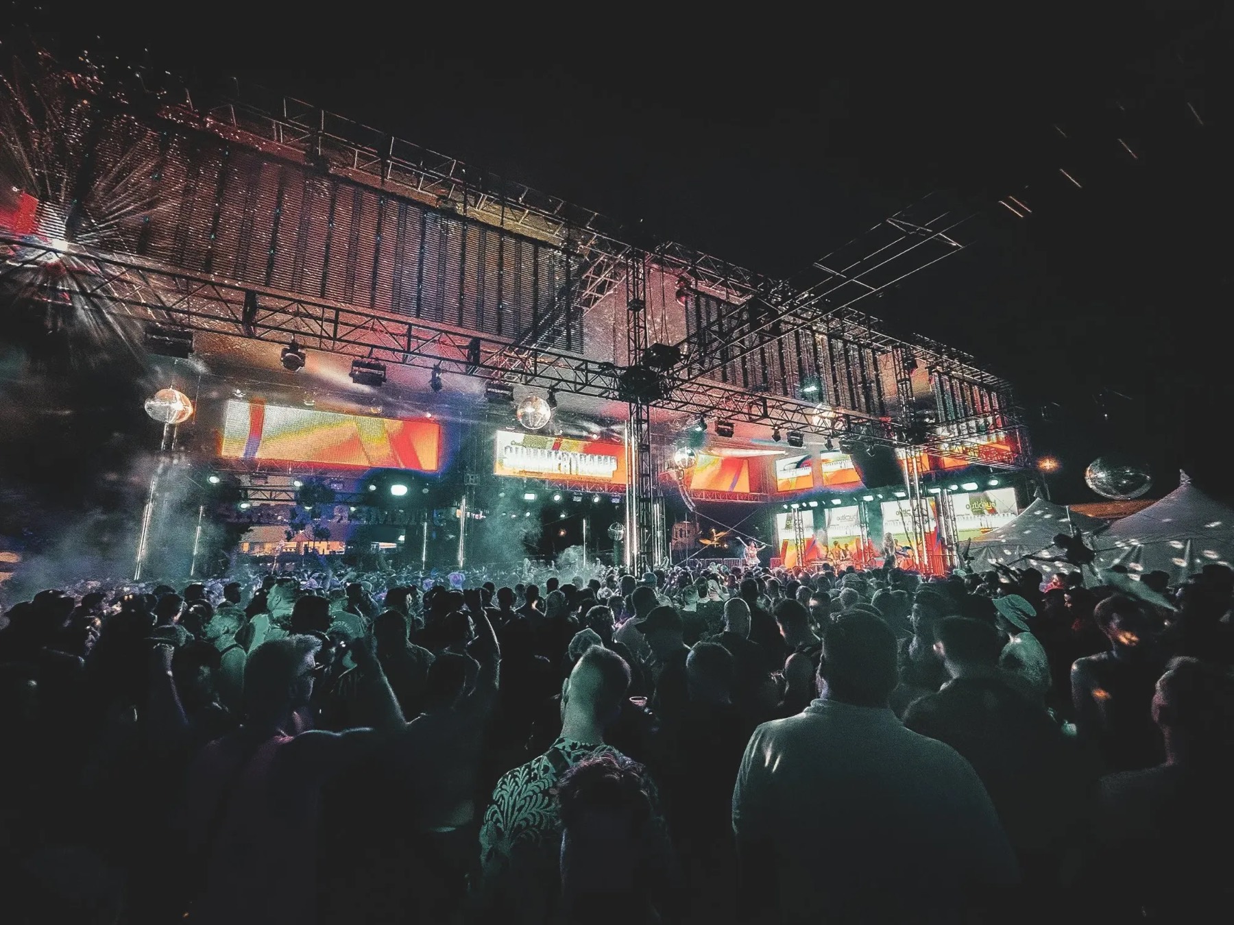 Outdoor festival stage with disco balls and truss