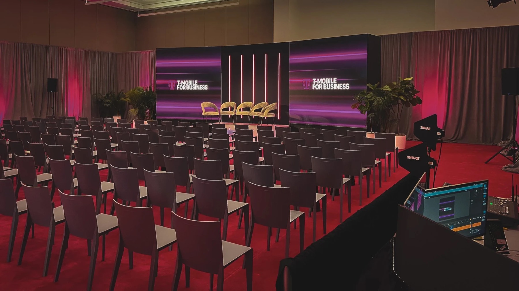 Branded panel stage with neon columns